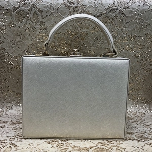 Champagne gold evening clutch with textured leather, metallic buckle, and handle detail