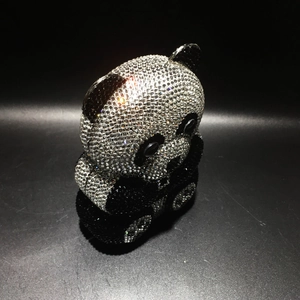 Detailed view of handmade panda crystal evening clutch with sparkling black and white rhinestones