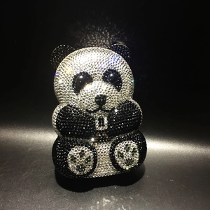 Exquisite close-up of handmade black and white crystals on panda animal evening clutch