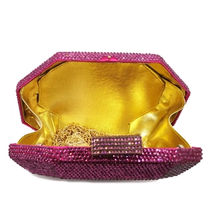 Detail of pink rhinestone evening bag with gold metal lining and detachable chain strap