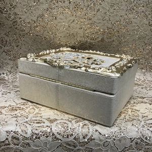 Detail of champagne gold jewelry box with sparkling rhinestones and metal pattern