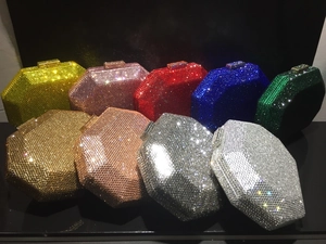 Macro shot of octagonal clutch bags in various rhinestone colors with metal clasps