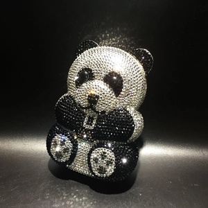 Exquisite close-up of the black and white crystal inlay on a panda-shaped evening bag