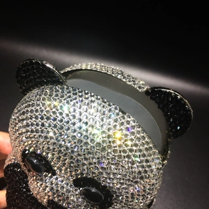 Close-up of sparkling black and white crystal rhinestones on a panda-shaped evening bag