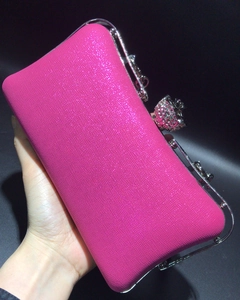 Detail of rose pink glitter evening clutch bag with diamond-encrusted spherical metal clasp