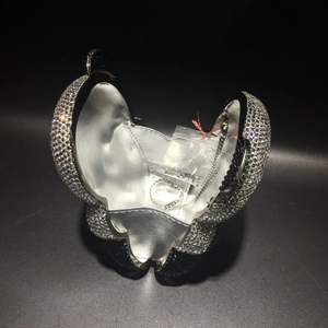 Detail of panda crystal clutch bag interior showing silver lining and metal chain strap