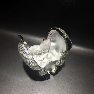 Detail of panda crystal clutch bag interior showing silver lining and metal chain strap
