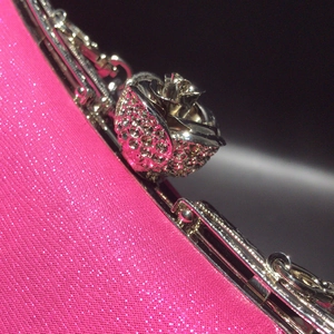Detail of rose pink glitter evening clutch with silver metallic 3D rose flower clasp