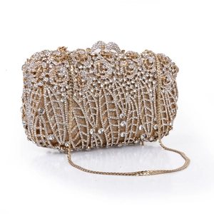 Macro detail of golden hollowed rose evening bag with sparkling crystal rhinestones