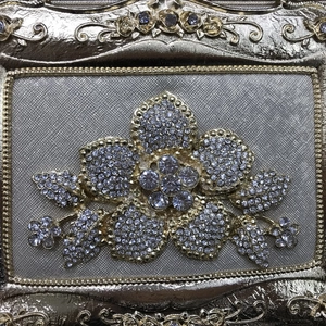 Elegant gold evening bag with large crystal flower design and luxury diamond texture