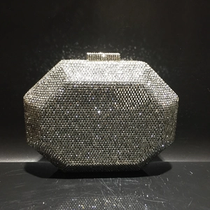 Detailed front view of octagonal silver crystal evening clutch with rhinestone clasp