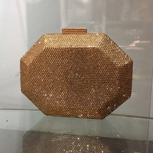 Detail of octagonal gold evening clutch bag with dense crystal rhinestone embellishments