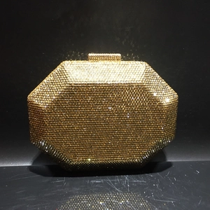 Macro detail of the golden octagonal evening clutch bag with sparkling crystal rhinestones