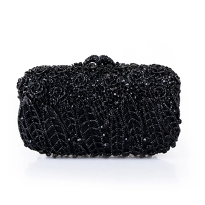 Detailed view of luxury black crystal floral embroidery on a metal evening clutch bag