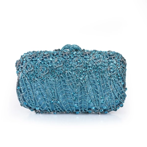 Detailed close-up of blue crystal evening clutch bag with sparkling 3D floral accents