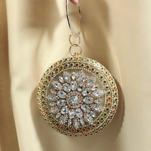Macro detail of luxury round evening bag with colorful crystals and gold ring handle