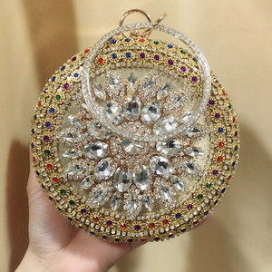 Detailed shot of a luxury round evening bag with colorful crystals and rhinestone handle
