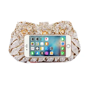 Exquisite floral crystal evening clutch with hollow metal rose and iPhone for size reference