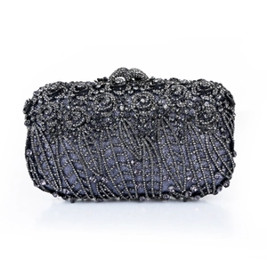 Detailed view of luxury evening clutch with hollow metal rose and crystal rhinestones