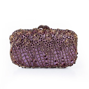 Detailed close-up of handmade purple crystal flower patterns on luxury evening clutch bag