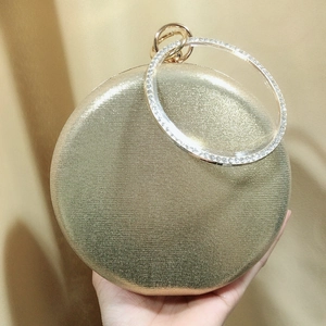 Luxury round gold evening clutch bag with sparkling diamond circular metal handle