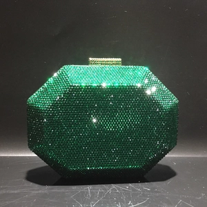 Detail of emerald green octagonal evening bag with sparkling rhinestones and gold clasp