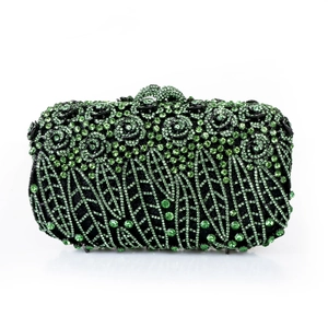 Macro shot of luxury evening clutch with green rhinestones and floral spiral patterns