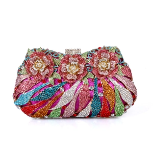 Close-up of luxury evening clutch with colorful crystal 3D flower and metal framework
