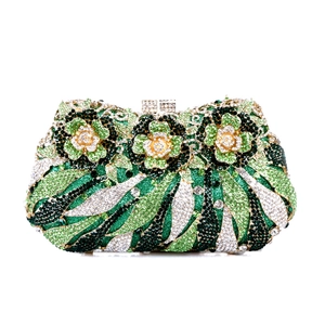 Detail of evening clutch featuring intricate floral rhinestone patterns and metal clasp