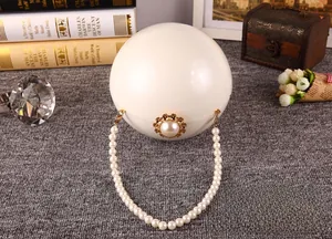 Détail du sac à main sphérique en perles avec poignée perlée et fermoir doré chic