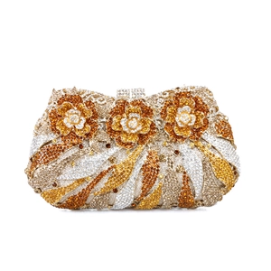 Macro shot of luxury evening clutch with gold rhinestones and three 3D floral accents