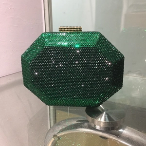 Detail of emerald green octagonal evening bag with dense rhinestone pave and gold clasp