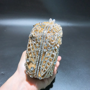 Detailed view of luxury gold owl evening bag encrusted with sparkling crystals