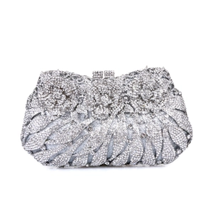 Detail of silver evening clutch featuring sparkling crystals and 3D rhinestone flower design
