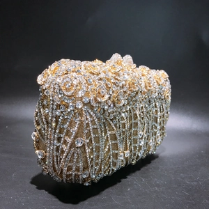 Close-up of golden rose晚宴包 encrusted with crystals and hollow metal floral details