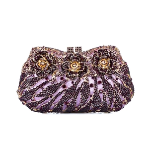 Detailed close-up of handmade purple crystal evening bag with 3D floral rhinestone patterns