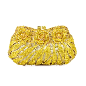 Exquisite close-up of golden rose detail and sparkling crystals on luxury evening clutch