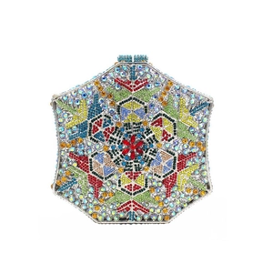 Macro shot of geometric snowflake evening clutch with colorful crystals and hollow metal frame