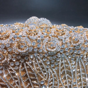 Luxury gold evening clutch with hollow floral pattern and sparkling crystal rhinestones
