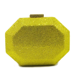Detail of octagonal clutch bag with bright yellow crystals and gold rectangular clasp