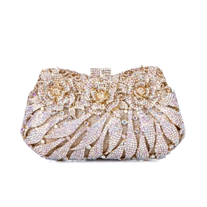 Detailed view of handmade crystal flower patterns and rhinestones on the golden evening bag