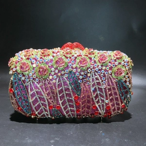 Detailed view of luxury hollow rose evening bag with crystal rhinestones and red lip clasp