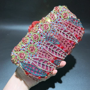 Detailed view of luxury floral clutch with colorful crystals and rose-shaped rhinestones