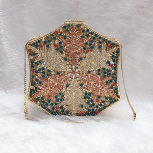Detailed view of luxury hexagonal evening bag featuring multi-color crystals and gold chain