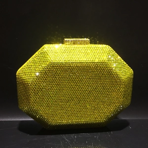 Detail of octagonal gold evening clutch with sparkling crystals and metal clasp