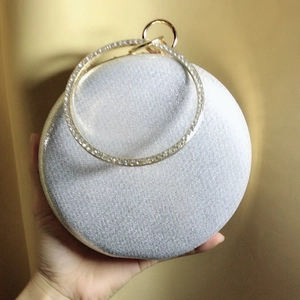 Silver glitter round evening bag with rhinestone ring handle and metal clasp closure