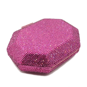 Close-up of rose red rhinestone evening bag with octagonal metal frame and clasp
