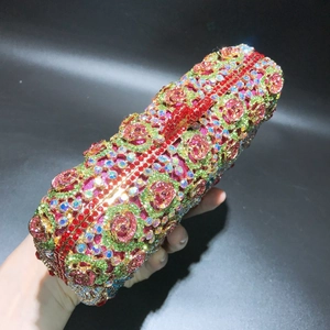 Handheld view of a luxury crystal evening clutch bag with rose floral rhinestone patterns