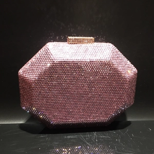 Close-up of pink crystal evening bag with octagon shape and sparkling rhinestones