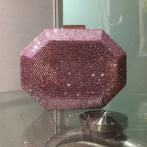 Detail of octagonal pink crystal evening bag with gold clasp and shimmering rhinestones